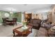 Spacious living room featuring a dining set and a brown leather couch at 7489 Gates Cir, Spring Hill, FL 34606