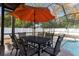 Enjoy meals by the pool under the shade of an umbrella at 7489 Gates Cir, Spring Hill, FL 34606