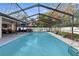 Refreshing pool area with screened enclosure at 7489 Gates Cir, Spring Hill, FL 34606