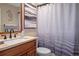 Well-lit bathroom with modern fixtures, wood vanity, and shower with curtain at 8194 Sturbridge Ct # A, Weeki Wachee, FL 34613
