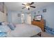 Cozy bedroom with ceiling fan, ensuite bathroom, and comfortable furnishings at 8194 Sturbridge Ct # A, Weeki Wachee, FL 34613