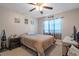 Bedroom features a ceiling fan, side table, and large window with natural light at 8194 Sturbridge Ct # A, Weeki Wachee, FL 34613