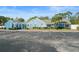 Exterior view of the community building showcasing its charming architecture and ample parking at 8194 Sturbridge Ct # A, Weeki Wachee, FL 34613