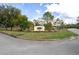 Inviting entrance to the community with lush landscaping and a decorative sign at 8194 Sturbridge Ct # A, Weeki Wachee, FL 34613