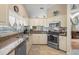 Bright kitchen features stainless steel appliances, granite countertops, and tile flooring at 8194 Sturbridge Ct # A, Weeki Wachee, FL 34613
