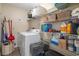 Functional laundry room equipped with a washer, dryer, and ample shelving for storage at 8194 Sturbridge Ct # A, Weeki Wachee, FL 34613