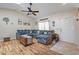 Inviting living room featuring wood-look floors, sectional couch, and an open, airy layout at 8194 Sturbridge Ct # A, Weeki Wachee, FL 34613