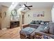 Bright living room with vaulted ceiling, skylight, ceiling fan, and comfortable seating arrangement at 8194 Sturbridge Ct # A, Weeki Wachee, FL 34613