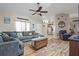 Open living room with wood-look floors, comfortable seating, and a seamless flow to the kitchen at 8194 Sturbridge Ct # A, Weeki Wachee, FL 34613