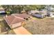 Aerial view of a single Gathering home with driveway, mature trees, and brick exterior at 8464 Dirlenton Way, Weeki Wachee, FL 34613