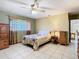 Bedroom with a ceiling fan, a bed with floral sheets, and an open doorway at 8464 Dirlenton Way, Weeki Wachee, FL 34613