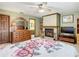 Bedroom with a bed, fireplace, dresser, and access to the bathroom at 8464 Dirlenton Way, Weeki Wachee, FL 34613