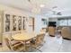 Open-concept dining area with a large table, chandelier, and tiled floors at 8464 Dirlenton Way, Weeki Wachee, FL 34613