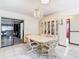 Bright dining room featuring a chandelier, display cabinet, and tile floors at 8464 Dirlenton Way, Weeki Wachee, FL 34613