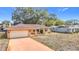 Charming single-story brick home featuring an attached garage and a well-maintained front yard at 8464 Dirlenton Way, Weeki Wachee, FL 34613