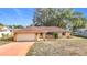 Charming single-story brick home featuring an attached garage and a well-maintained front yard at 8464 Dirlenton Way, Weeki Wachee, FL 34613