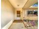 Inviting covered porch area with brick accents, decorative plants, and a security door entrance at 8464 Dirlenton Way, Weeki Wachee, FL 34613