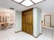 Hallway with closet, door, and view into the dining room at 8464 Dirlenton Way, Weeki Wachee, FL 34613