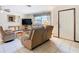 Inviting living room with a window, door, tile floors, and comfortable seating at 8464 Dirlenton Way, Weeki Wachee, FL 34613