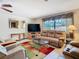 Comfortable living room boasts natural light, tile floors, and cozy furniture at 8464 Dirlenton Way, Weeki Wachee, FL 34613
