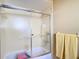 Enclosed shower with glass doors and chrome hardware in a neutral-toned bathroom at 8464 Dirlenton Way, Weeki Wachee, FL 34613