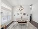 Dining room with large window, stylish chandelier, and seating for four at 8709 Maple Pond Ct, Trinity, FL 34655