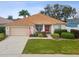 Charming single-story home featuring a well-maintained lawn and a welcoming front porch at 8709 Maple Pond Ct, Trinity, FL 34655