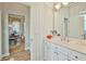 Clean bathroom showcasing white cabinetry, a sink, and an adjacent dining area at 9091 Alexandria Dr, Weeki Wachee, FL 34613
