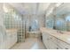 Spacious bathroom features dual vanities, tiled floors, and a relaxing tub with shuttered windows at 9091 Alexandria Dr, Weeki Wachee, FL 34613