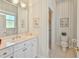 Neat bathroom featuring a white vanity, tile flooring, and a shower with glass doors at 9091 Alexandria Dr, Weeki Wachee, FL 34613