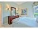 Comfortable bedroom with a double bed, floral curtains, and a dark wood dresser with decorative accents at 9091 Alexandria Dr, Weeki Wachee, FL 34613