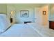 Bright bedroom featuring neutral paint, carpet, a white comforter, and access to the ensuite bathroom at 9091 Alexandria Dr, Weeki Wachee, FL 34613