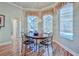 Inviting breakfast nook featuring a charming table, bright windows, and a view of the screened-in pool area at 9091 Alexandria Dr, Weeki Wachee, FL 34613