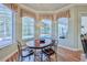 Bright breakfast nook with views of the pool, a wood table, and seating for four provides an intimate dining experience at 9091 Alexandria Dr, Weeki Wachee, FL 34613
