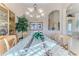 Formal dining room features an elegant chandelier, a display cabinet, and tray ceiling at 9091 Alexandria Dr, Weeki Wachee, FL 34613