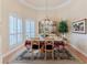 Formal dining room with tray ceilings, shuttered windows, and elegant decor at 9091 Alexandria Dr, Weeki Wachee, FL 34613
