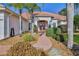 Inviting entryway with mature shrubs, rock ground cover, and brick walkway at 9091 Alexandria Dr, Weeki Wachee, FL 34613