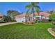Well-maintained lawn and landscaping frame this home with an inviting brick driveway at 9091 Alexandria Dr, Weeki Wachee, FL 34613