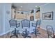 Kitchen bar with three stools provides ample seating at the bar for casual dining and entertaining at 9091 Alexandria Dr, Weeki Wachee, FL 34613
