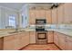 Kitchen with stainless steel appliances and wood cabinets provides a chef with everything he needs at 9091 Alexandria Dr, Weeki Wachee, FL 34613
