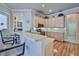 Kitchen bar overlooks breakfast nook and living room and features wood cabinets and granite countertops at 9091 Alexandria Dr, Weeki Wachee, FL 34613