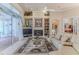 Bright living room with a fireplace, built-in shelving, and access to the screened patio at 9091 Alexandria Dr, Weeki Wachee, FL 34613