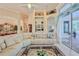 Inviting living room featuring a large sectional, tile floors, and lots of natural light at 9091 Alexandria Dr, Weeki Wachee, FL 34613