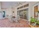 Covered patio with dining set, ceiling fans, tile floors, and views of the pool and lush landscaping at 9091 Alexandria Dr, Weeki Wachee, FL 34613