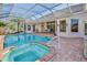 Sparkling screened pool and spa with brick patio, perfect for outdoor entertaining and relaxation at 9091 Alexandria Dr, Weeki Wachee, FL 34613
