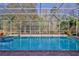 Inviting screened pool with spa, brick-paved deck, and views of the private backyard at 9091 Alexandria Dr, Weeki Wachee, FL 34613