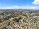 Wide aerial shot showcasing the neighborhood layout, lush landscaping, and community lakes at 18819 Sunterra Dr, Land O Lakes, FL 34638