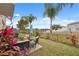 Relaxing back patio featuring comfortable seating and lush landscaping with tranquil views of the water at 18819 Sunterra Dr, Land O Lakes, FL 34638