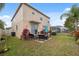 Backyard featuring a covered patio area with outdoor seating and green space at 18819 Sunterra Dr, Land O Lakes, FL 34638