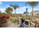 Backyard patio with palm trees, outdoor seating, and views of the pond at 18819 Sunterra Dr, Land O Lakes, FL 34638